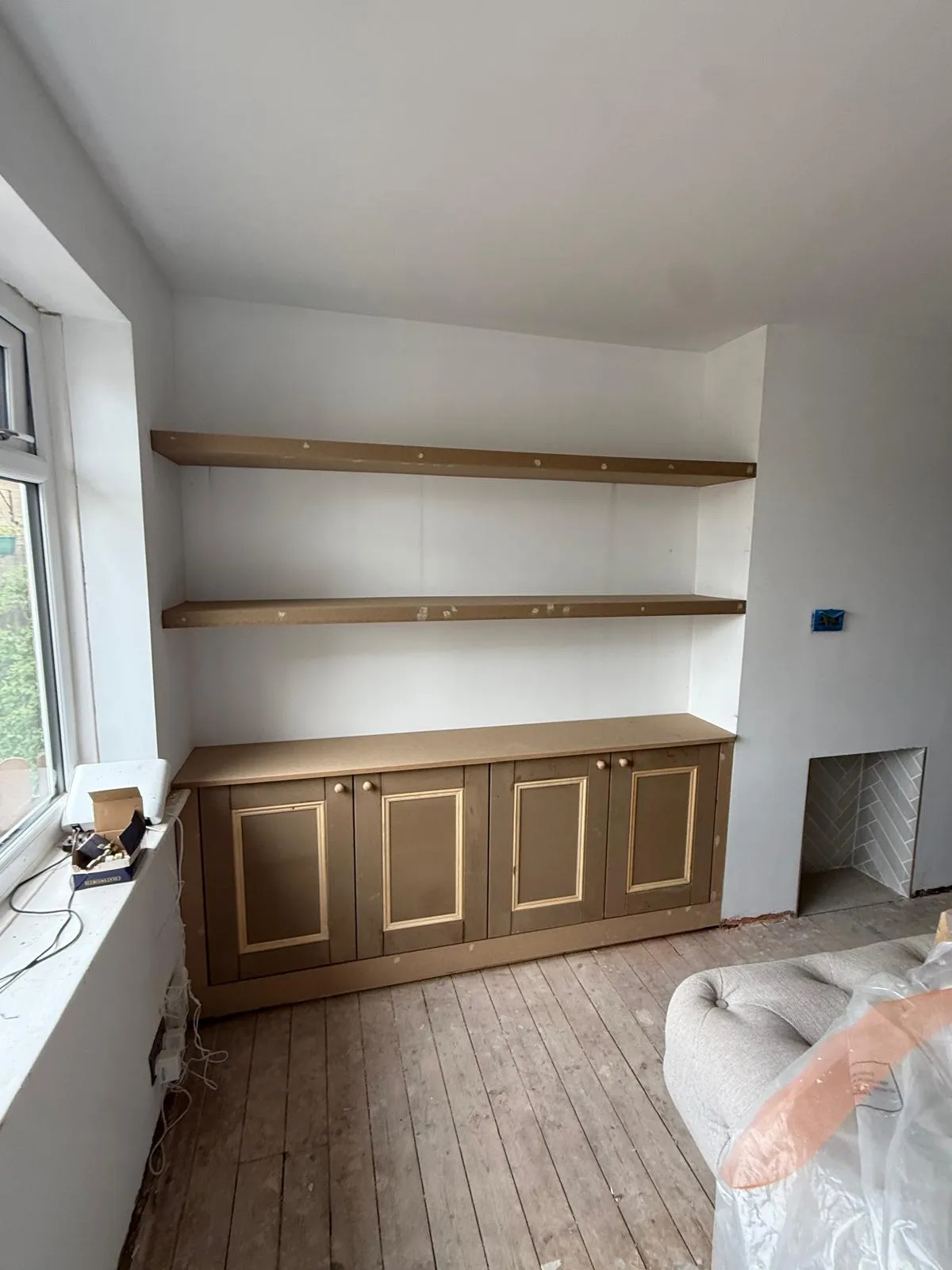 Bespoke alcove base cupboards and floating shelves custom scribed to wall