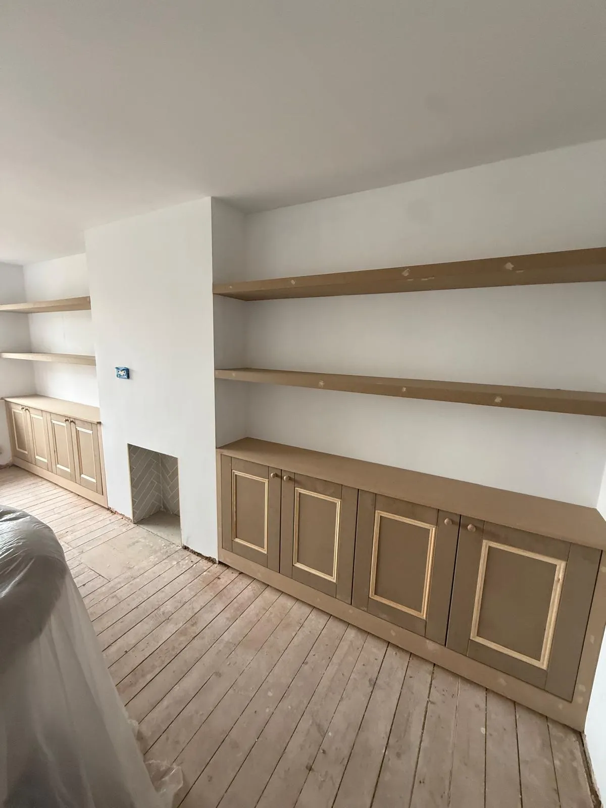 Chunky floating alcove shelves and symmetrical lower storage cupboards